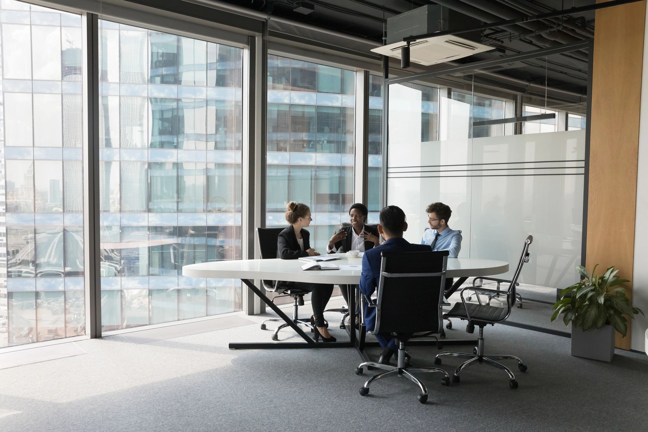 Diverse business team talking in meeting room